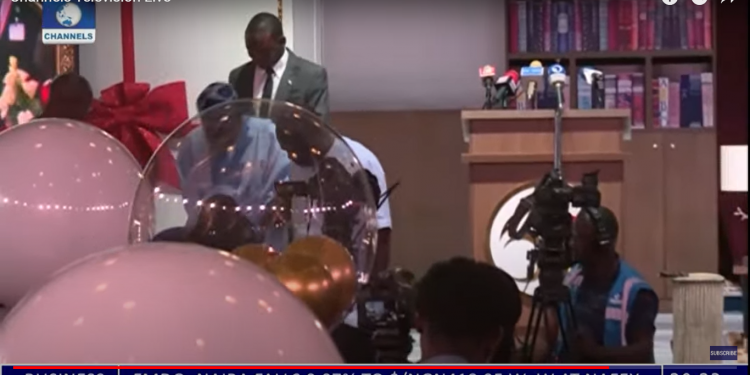 TINUBU`S HEALTH: APC candidate supported by an aide while climbing down the podium after a speech on Sunday