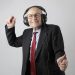 Elderly retireee in black suit dancing