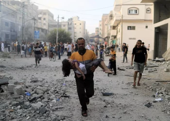 A man carrying wounded child