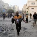 A man carrying wounded child